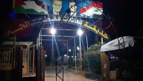 The Assads' pictures at the entrance to a children's playground in Douma